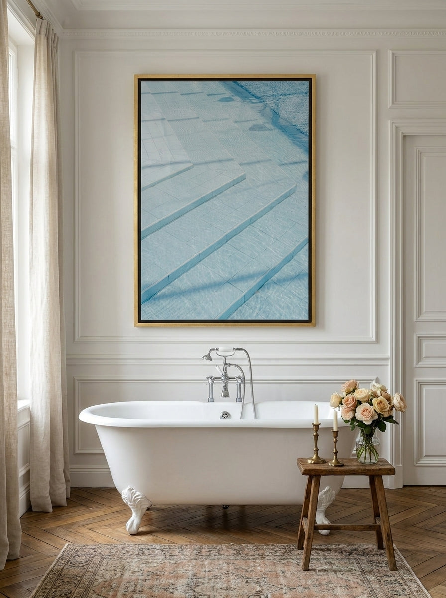 Canvas wall art with a gold leaf surround styled on the wall in a Parisian bathroom