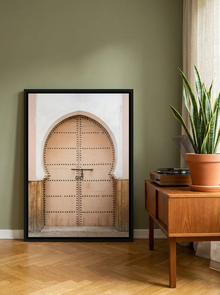 Canvas wall art with a black surround leaning against the wall in a mid-century living room