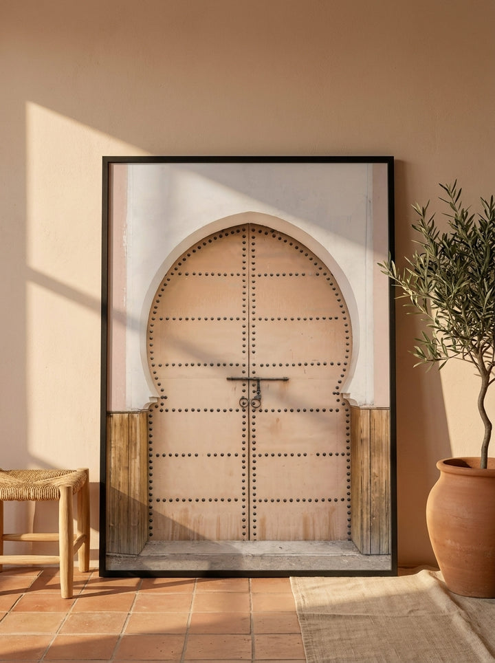 Oversized statement modern wall art print leaning against the wall in a Mediterranean bedroom