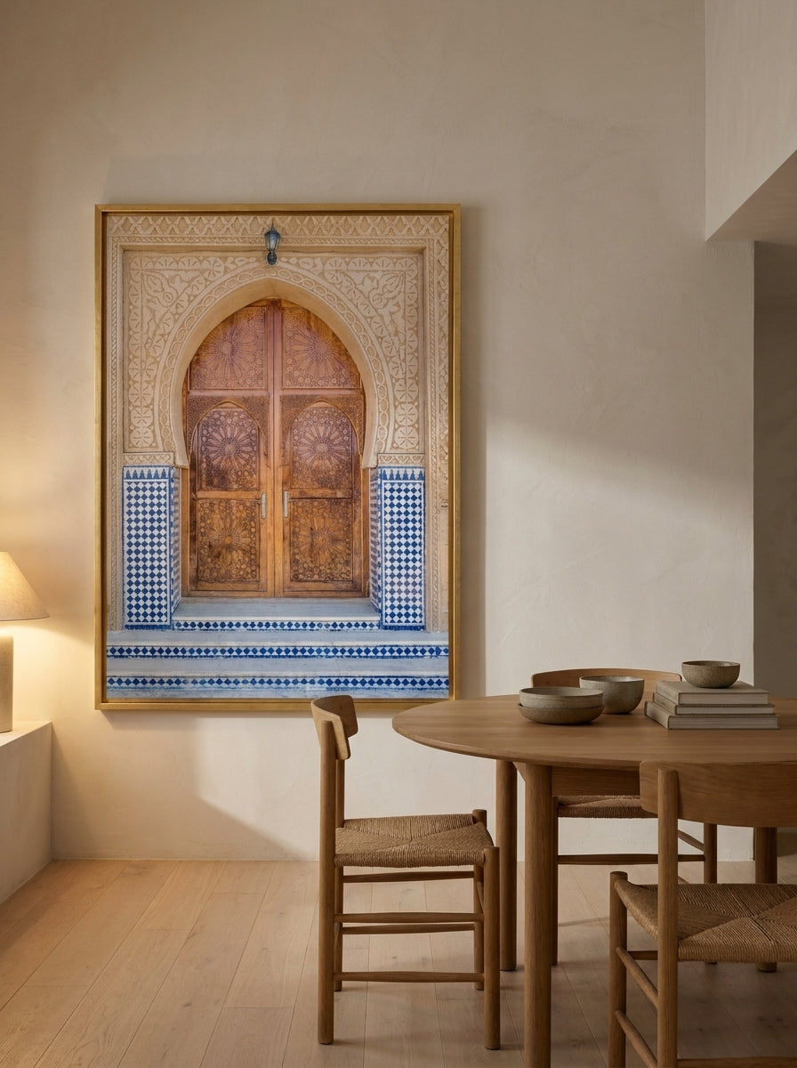 Oversized statement canvas wall art with a gold leaf surround styled on the wall in a warm Japandi dining room