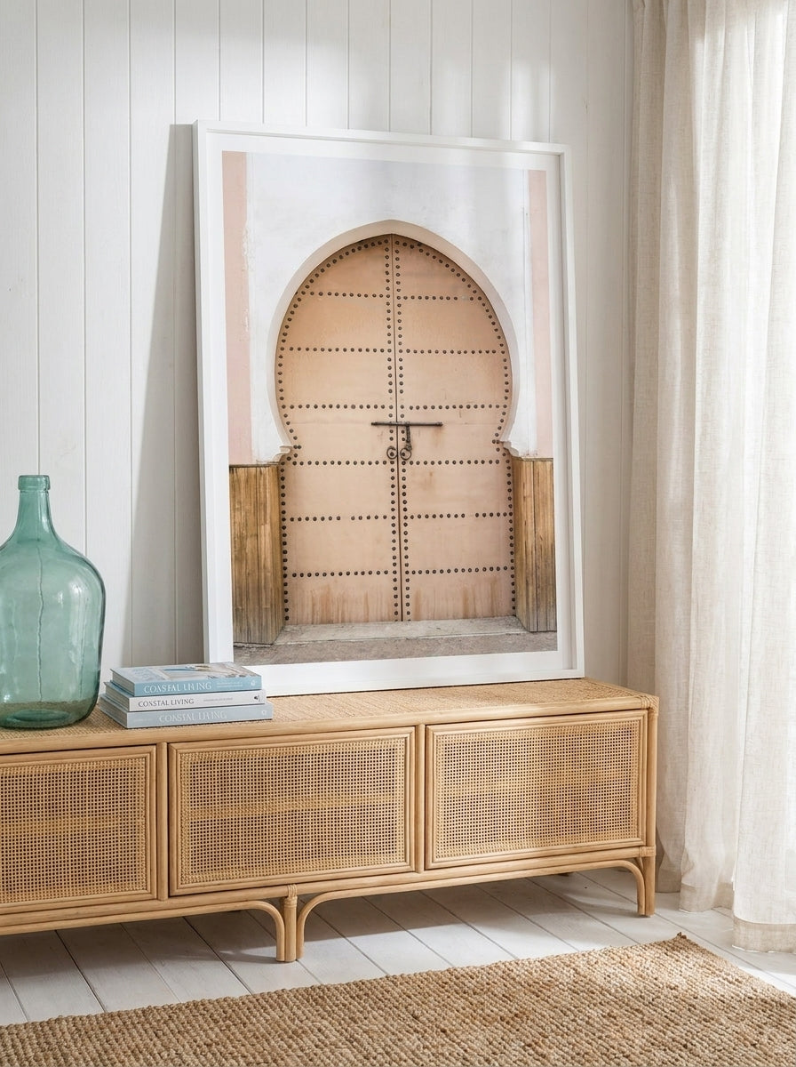 Modern wall art print standing on a sideboard in a coastal home office