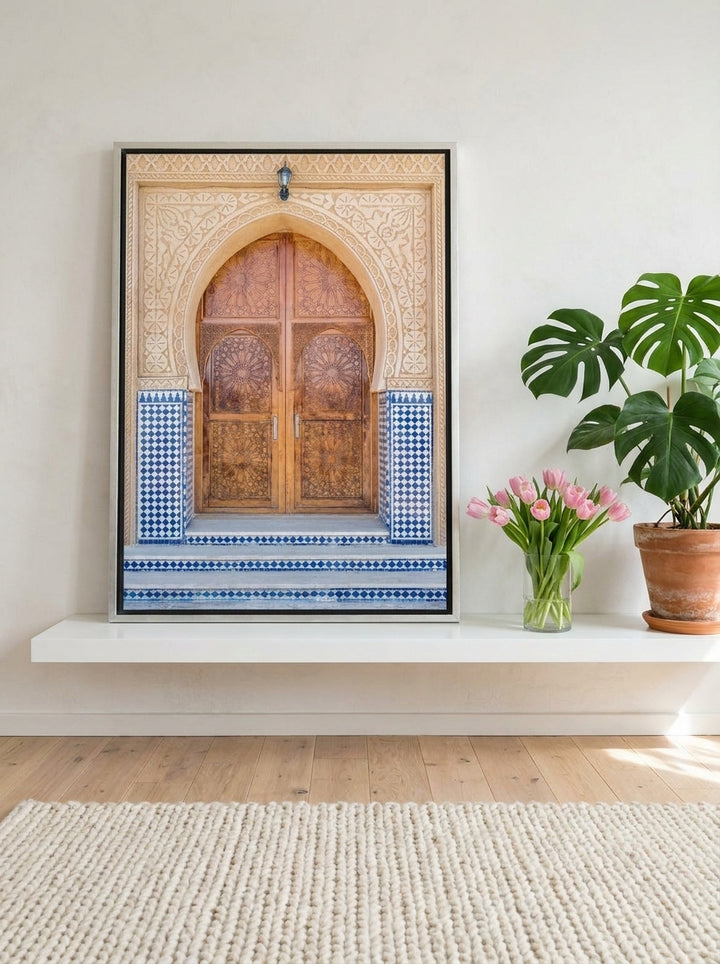 Canvas wall art with a silver leaf surround standing on a shelf in a bright Scandinavian bedroom
