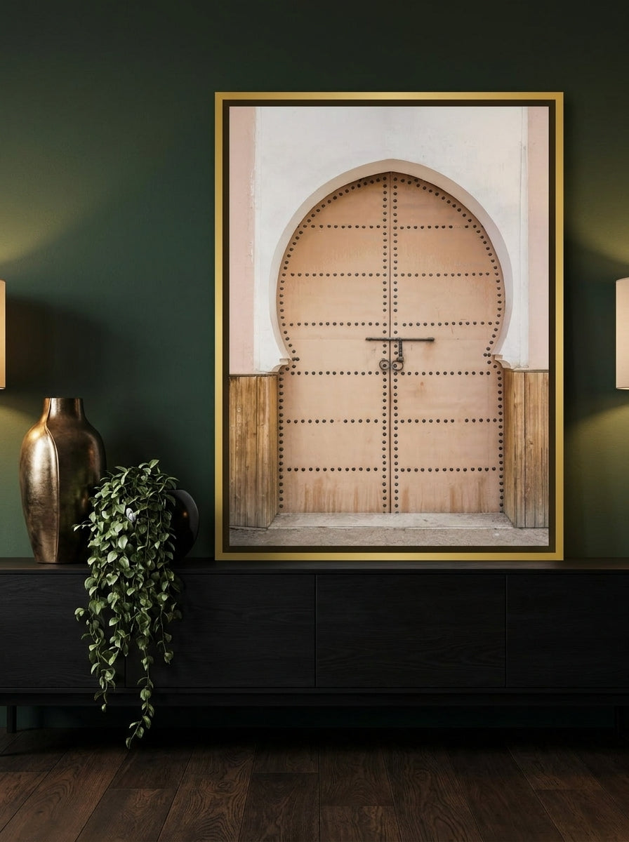 Canvas wall art with a gold leaf surround standing on a console in a moody home office