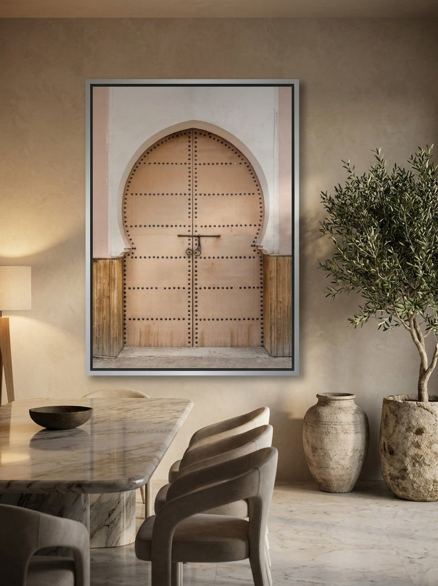 Oversized statement canvas wall art with a silver leaf surround styled on the wall in a luxe dining room