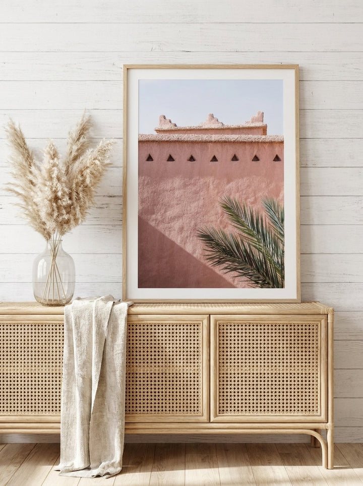 Modern wall art print standing on a sideboard in a coastal living room