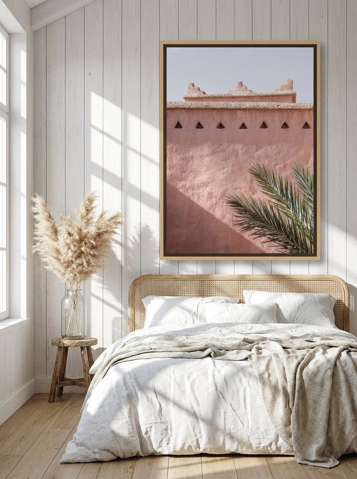 Oversized statement canvas wall art with a natural timber surround styled on the wall in a coastal bedroom