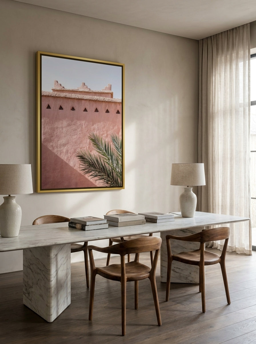 Oversized statement canvas wall art with a gold leaf surround styled on the wall in a luxe dining room