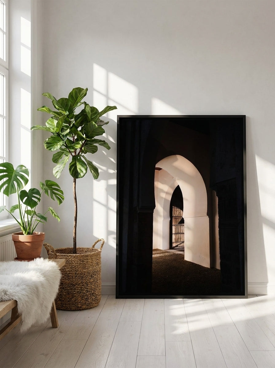 Canvas wall art with a black surround leaning against the wall in a bright Scandinavian living room