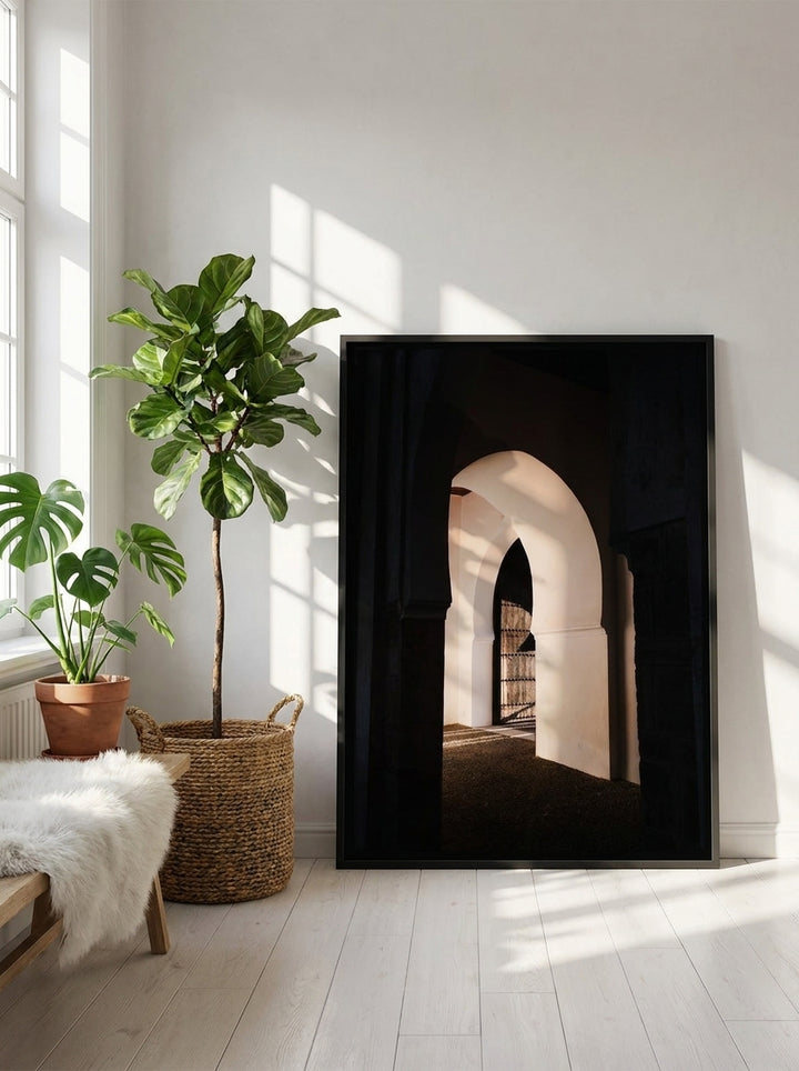 Canvas wall art with a black surround leaning against the wall in a bright Scandinavian living room