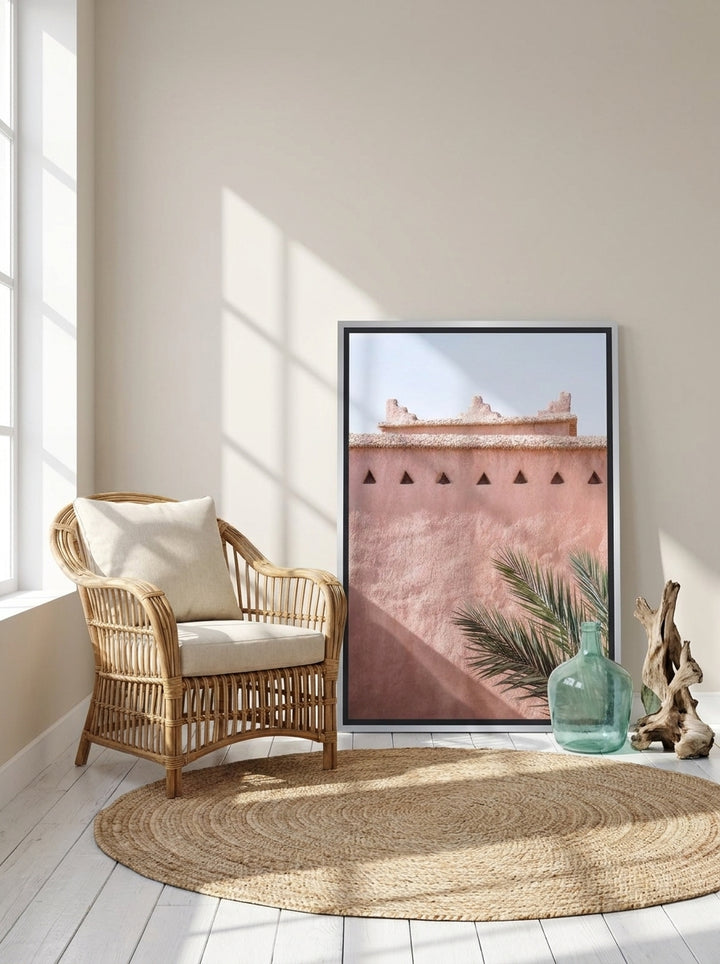 Canvas wall art with a silver leaf surround leaning against the wall in a coastal bedroom