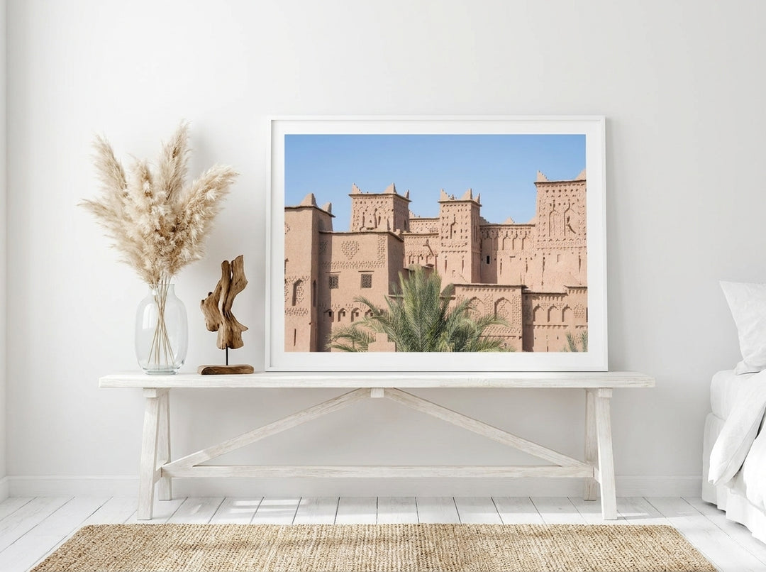 Modern wall art print standing on a console in a coastal bedroom