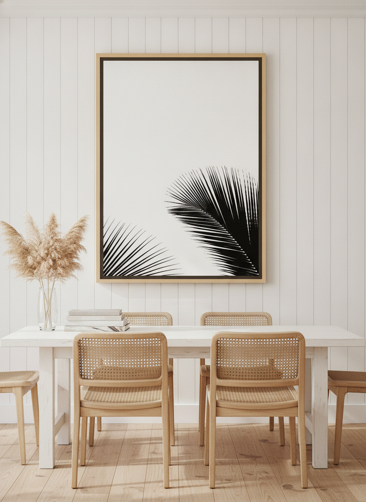 Oversized statement canvas wall art with a natural timber surround styled on the wall in a coastal dining room