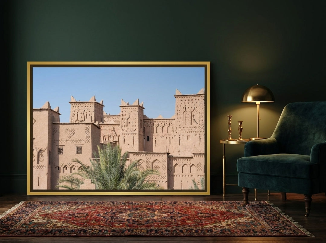 Canvas wall art with a gold leaf surround leaning against the wall in a moody home office