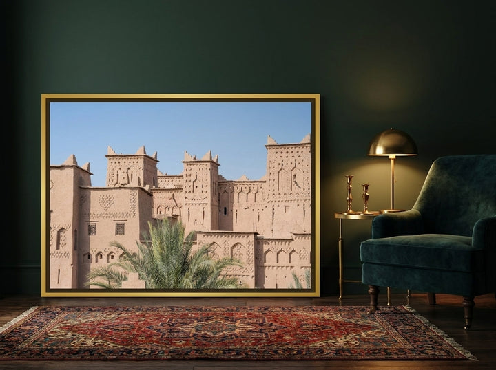 Canvas wall art with a gold leaf surround leaning against the wall in a moody home office