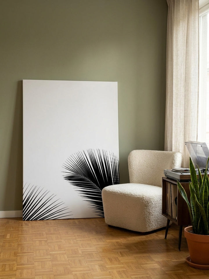Stretched canvas wall art leaning against the wall in a mid-century bedroom