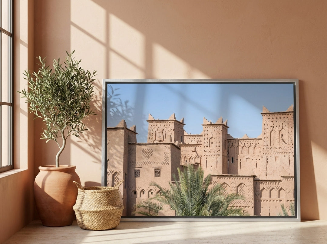 Canvas wall art with a silver leaf surround leaning against the wall in a Mediterranean bedroom