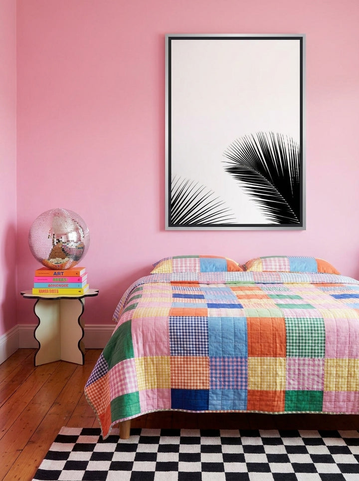 Canvas wall art with a silver leaf surround styled on the wall in a colourful eclectic bedroom