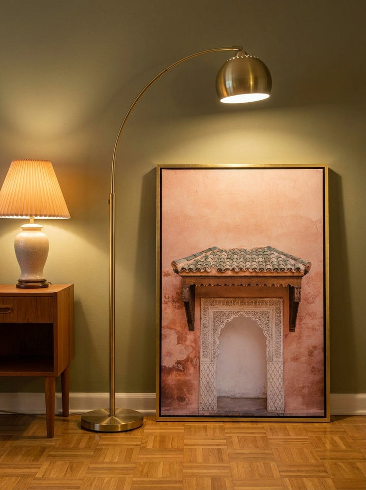 Canvas wall art with a gold leaf surround leaning against the wall in a mid-century home office
