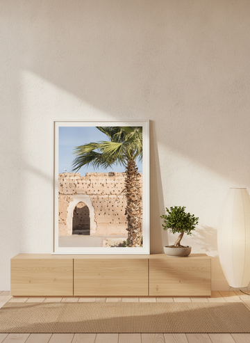 Modern wall art print standing on a sideboard in a warm Japandi bedroom