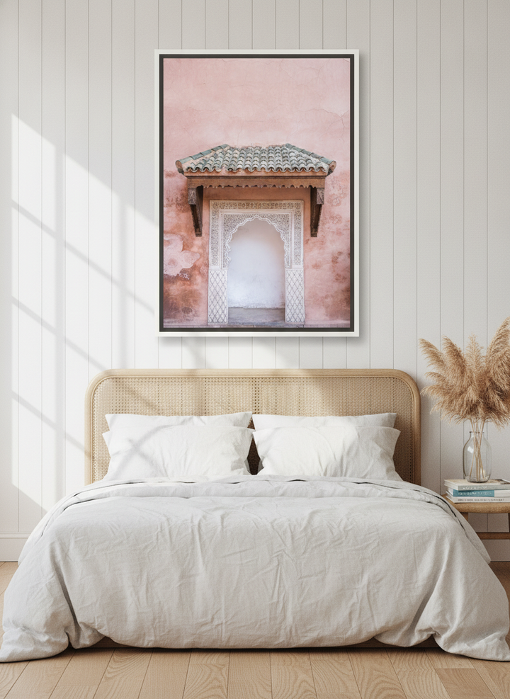 Canvas wall art with a white surround styled on the wall in a coastal bedroom