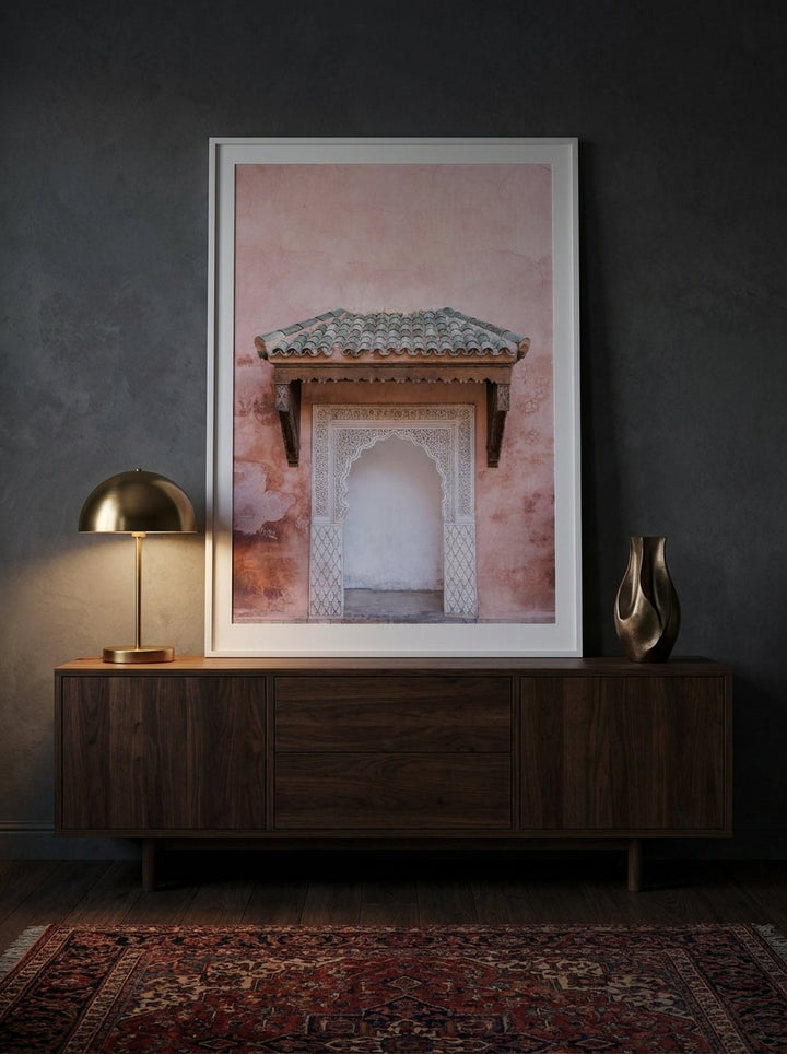 Modern wall art print standing on a sideboard in a moody home office