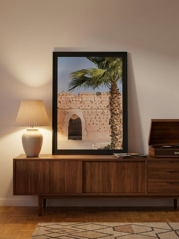 Modern wall art print standing on a sideboard in a mid-century living room
