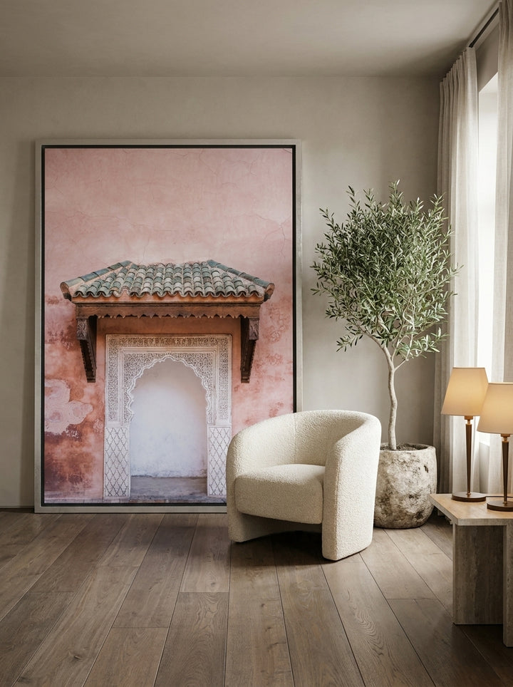 Oversized statement canvas wall art with a silver leaf surround leaning against the wall in a luxe bedroom