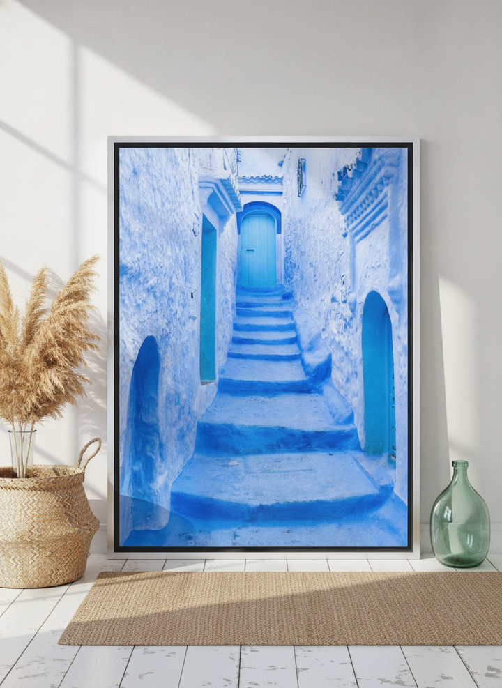 Canvas wall art with a silver leaf surround leaning against the wall in a coastal bathroom
