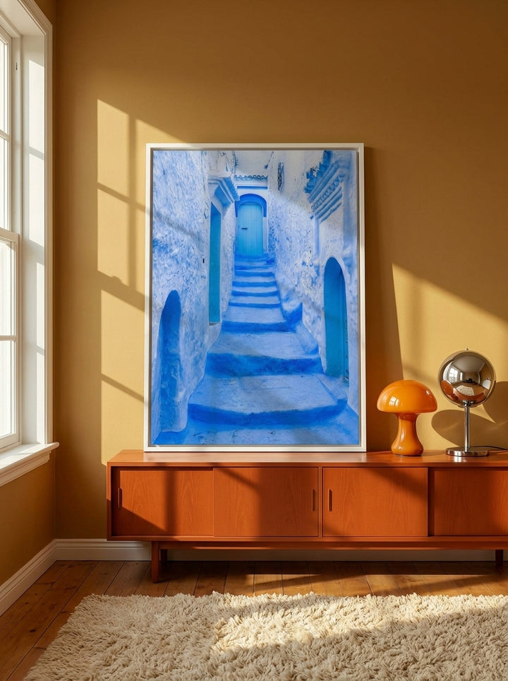 Canvas wall art with a white surround standing on a sideboard in a retro 70s bedroom