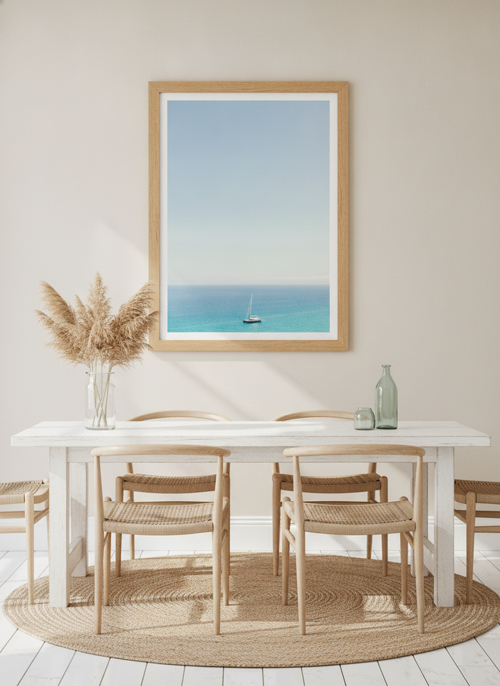 Modern wall art print styled on the wall in a coastal dining room