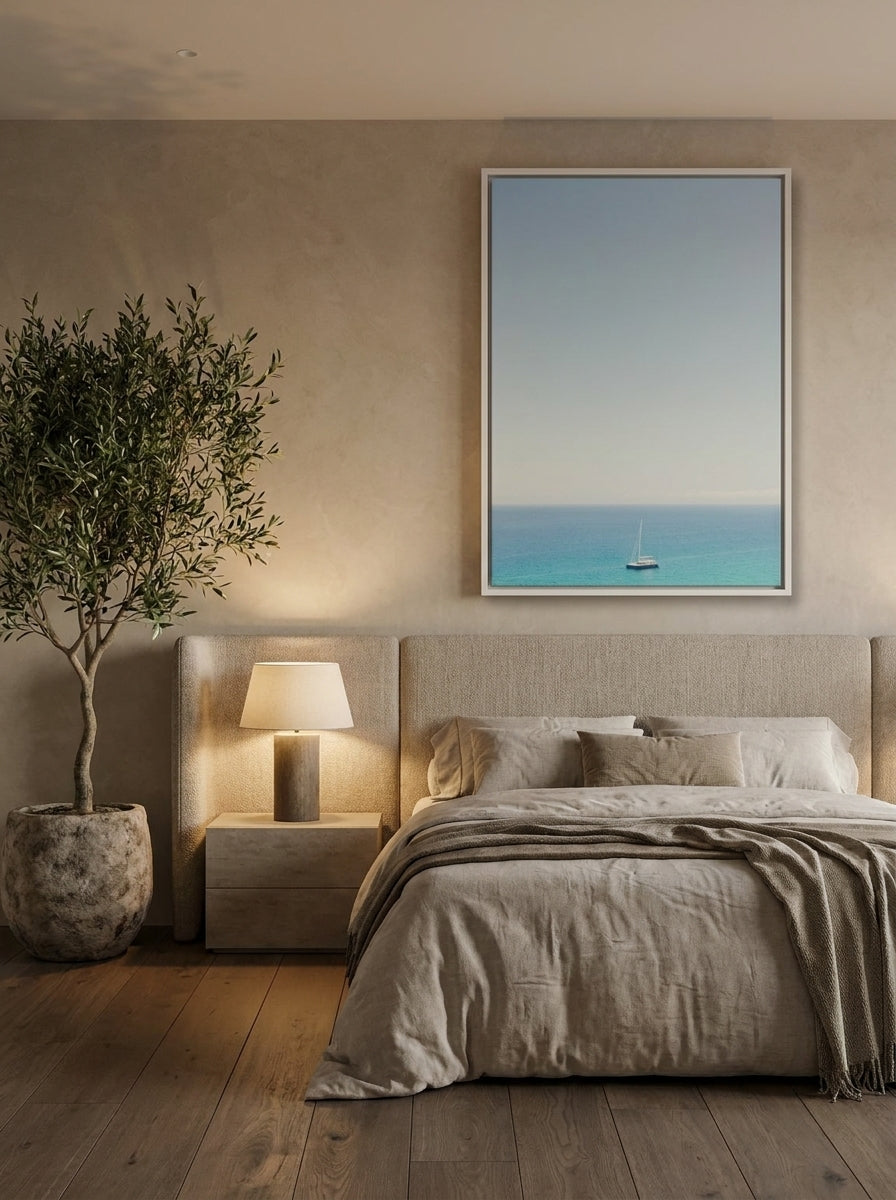Oversized statement canvas wall art with a white surround styled on the wall in a luxe bedroom