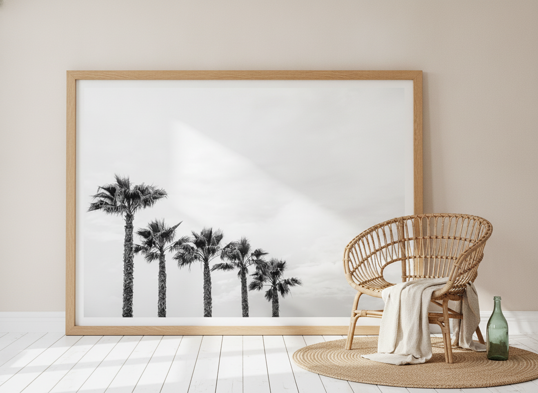 Oversized statement modern wall art print leaning against the wall in a coastal living room