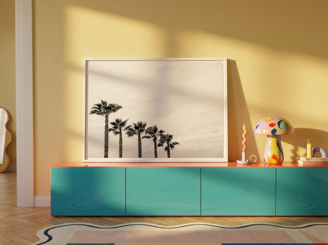 Canvas wall art with a white surround standing on a sideboard in a colourful eclectic bedroom