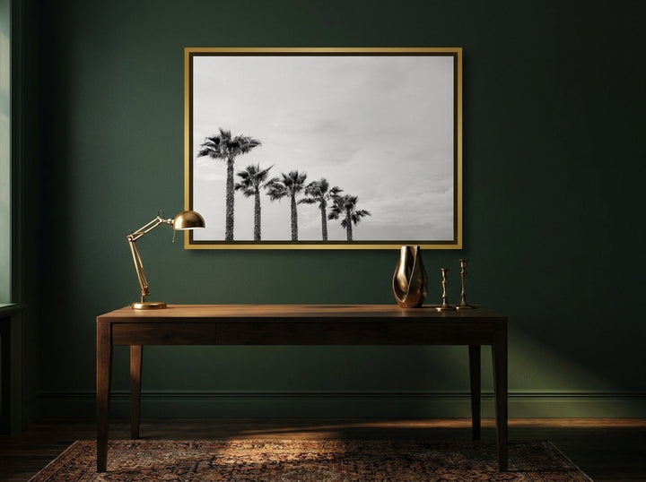 Canvas wall art with a gold leaf surround styled on the wall in a moody home office