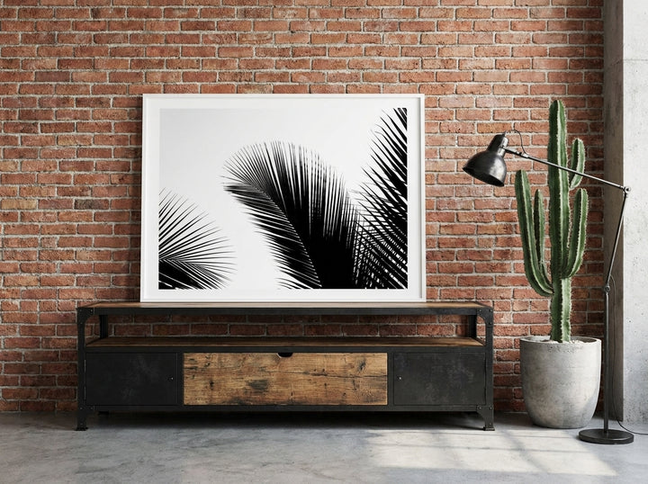 Modern wall art print standing on a console in an industrial loft bedroom