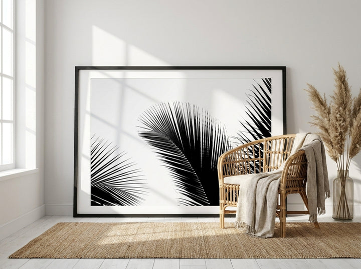 Oversized statement modern wall art print leaning against the wall in a coastal bedroom