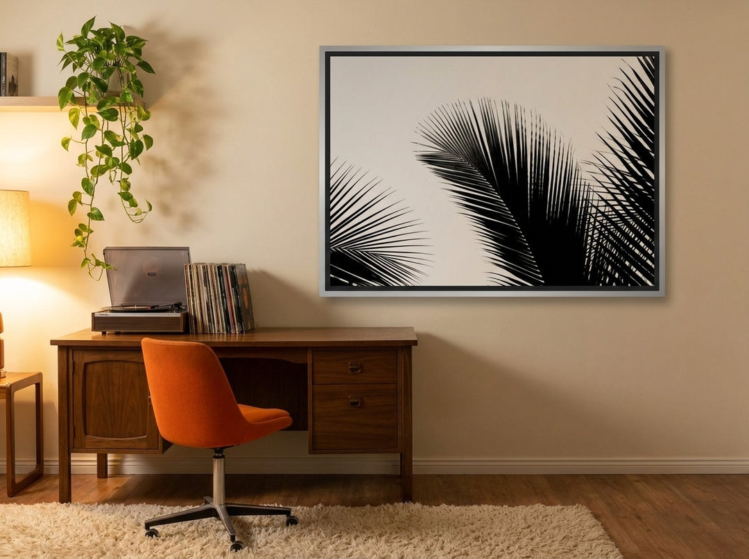 Canvas wall art with a silver leaf surround styled on the wall in a retro 70s home office