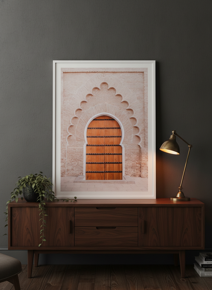Modern wall art print standing on a sideboard in a moody home office