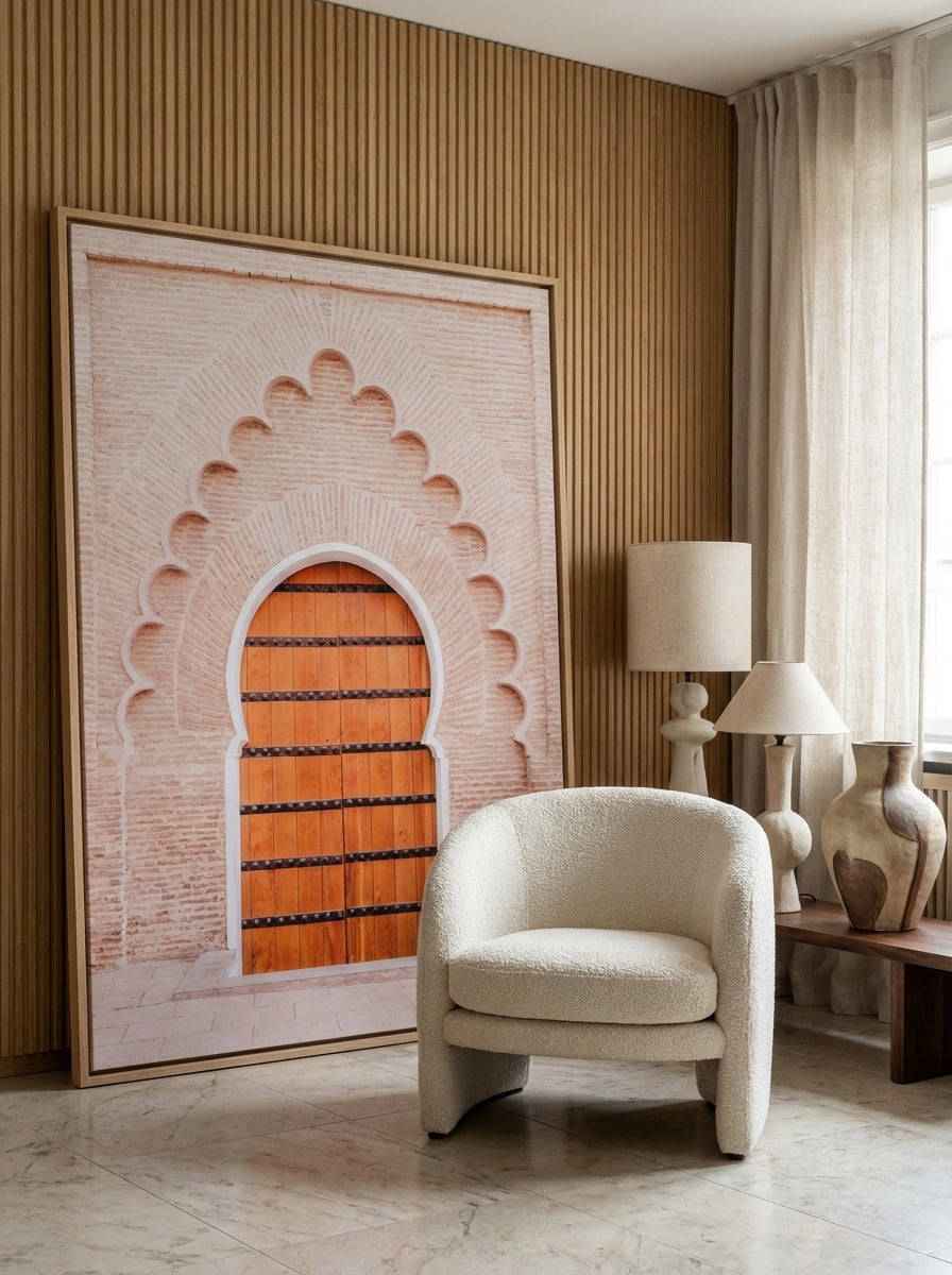Oversized statement canvas wall art with a natural timber surround leaning against the wall in a luxe living room