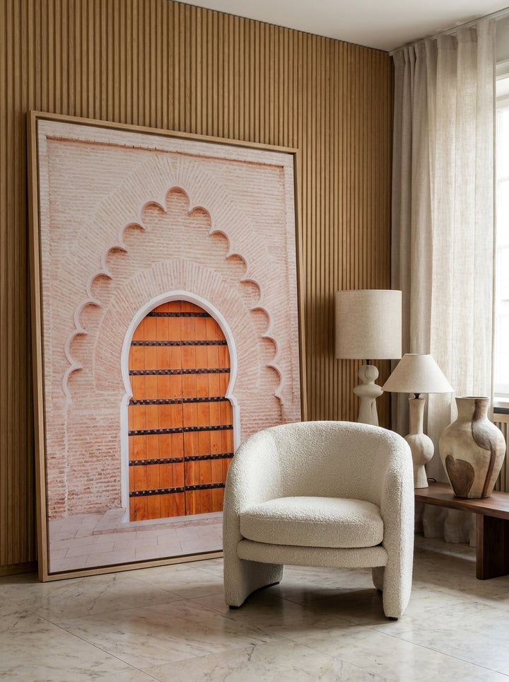 Oversized statement canvas wall art with a natural timber surround leaning against the wall in a luxe living room