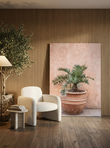 Stretched canvas wall art leaning against the wall in a luxe bedroom