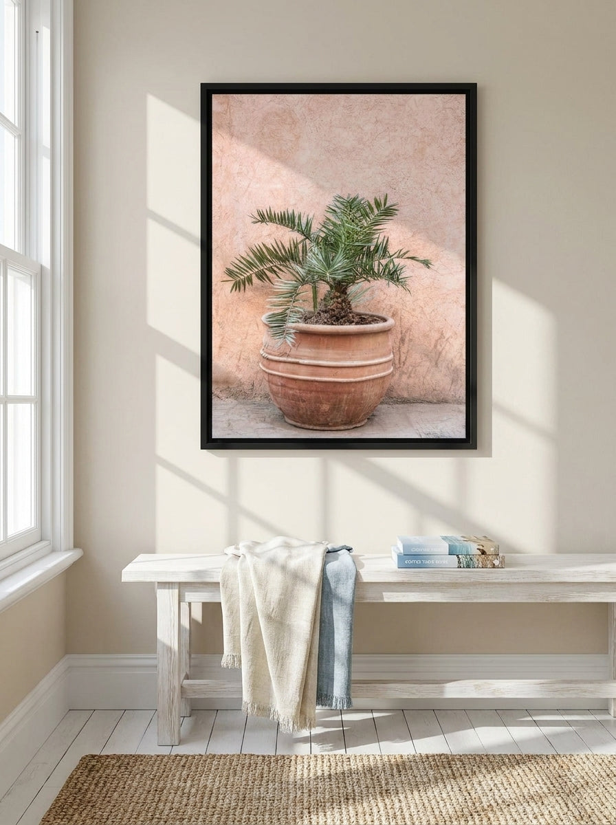 Canvas wall art with a black surround styled on the wall in a coastal living room