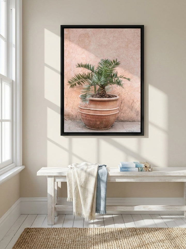 Canvas wall art with a black surround styled on the wall in a coastal living room