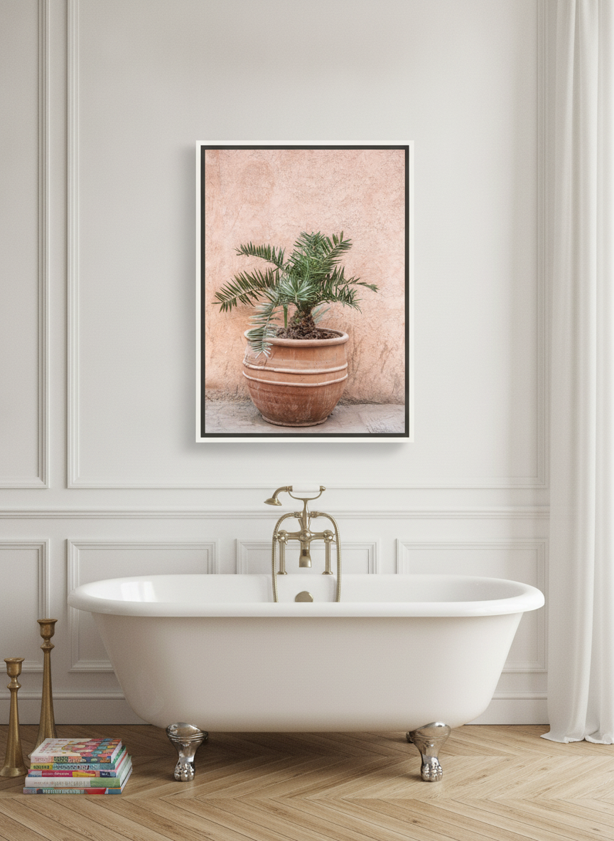 Canvas wall art with a white surround styled on the wall in a Parisian bathroom