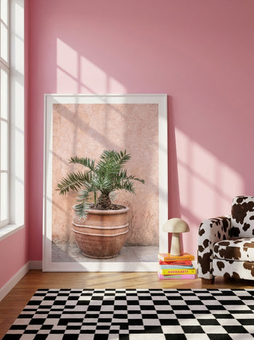 Oversized statement modern wall art print leaning against the wall in a colourful eclectic living room