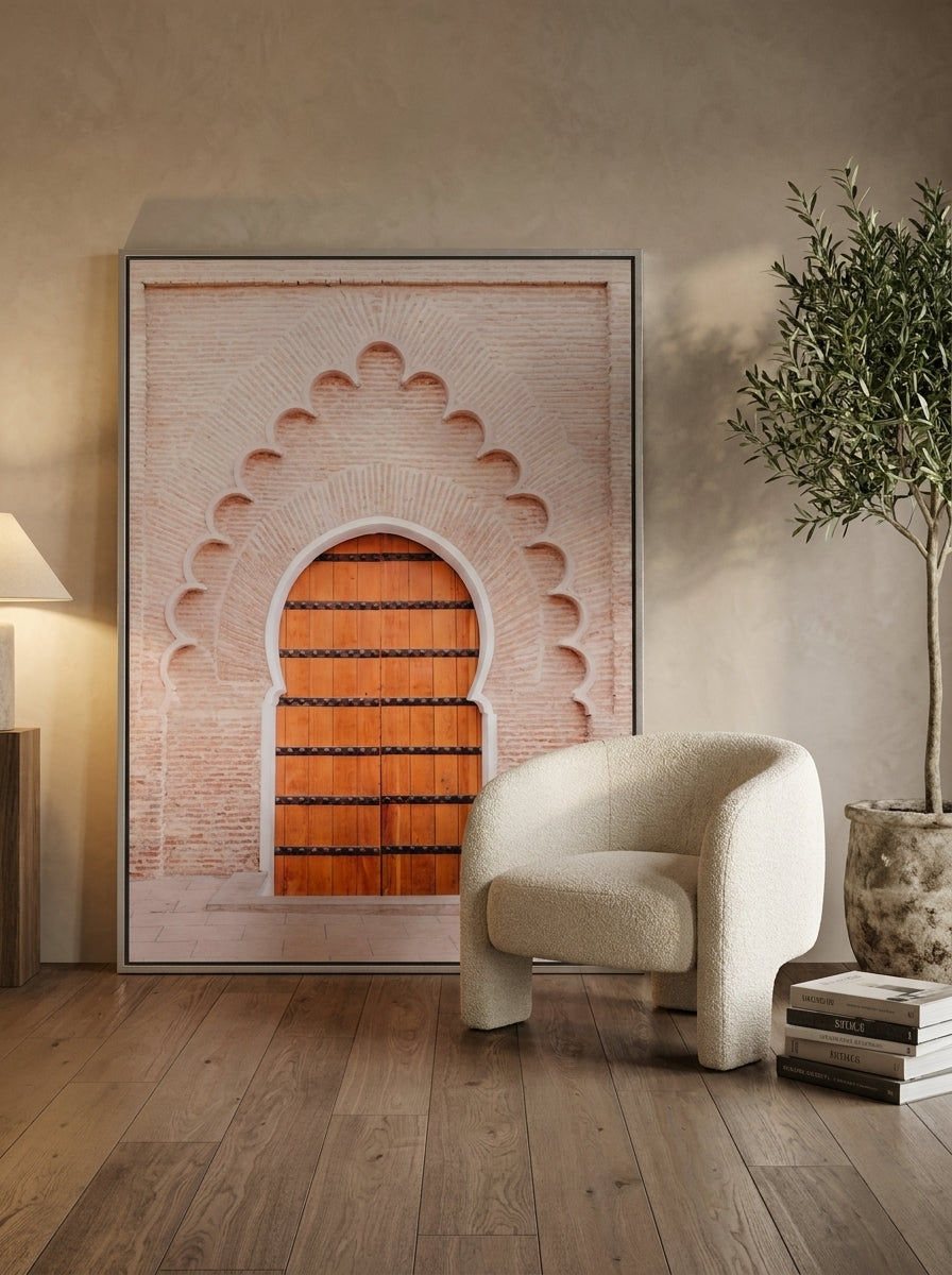 Oversized statement canvas wall art with a silver leaf surround leaning against the wall in a luxe living room