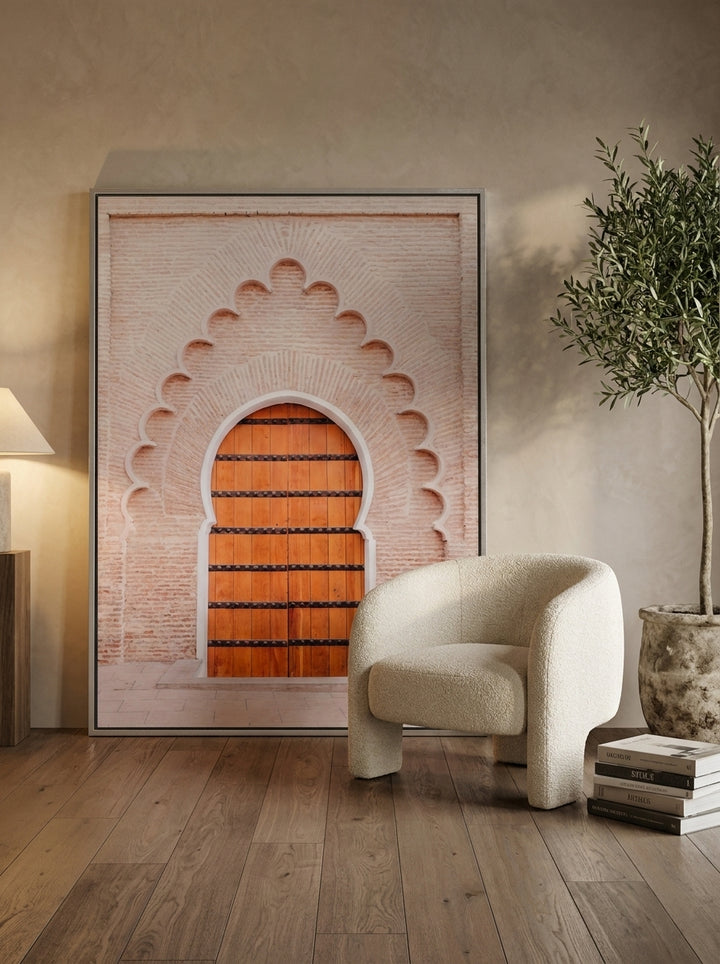 Oversized statement canvas wall art with a silver leaf surround leaning against the wall in a luxe living room