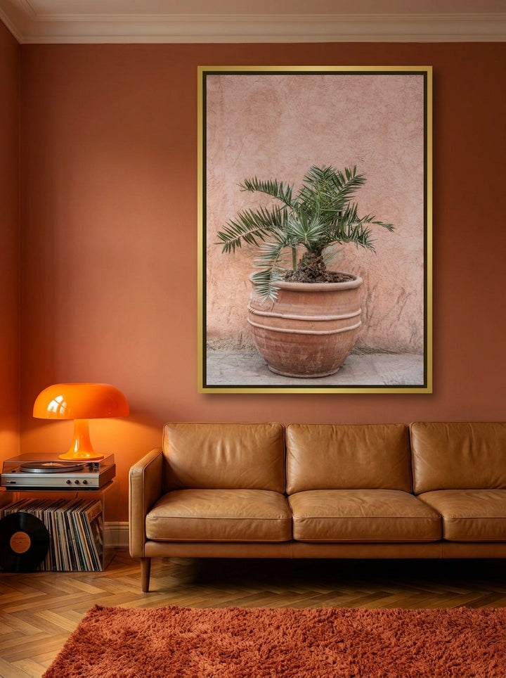 Oversized statement canvas wall art with a gold leaf surround styled on the wall in a retro 70s living room