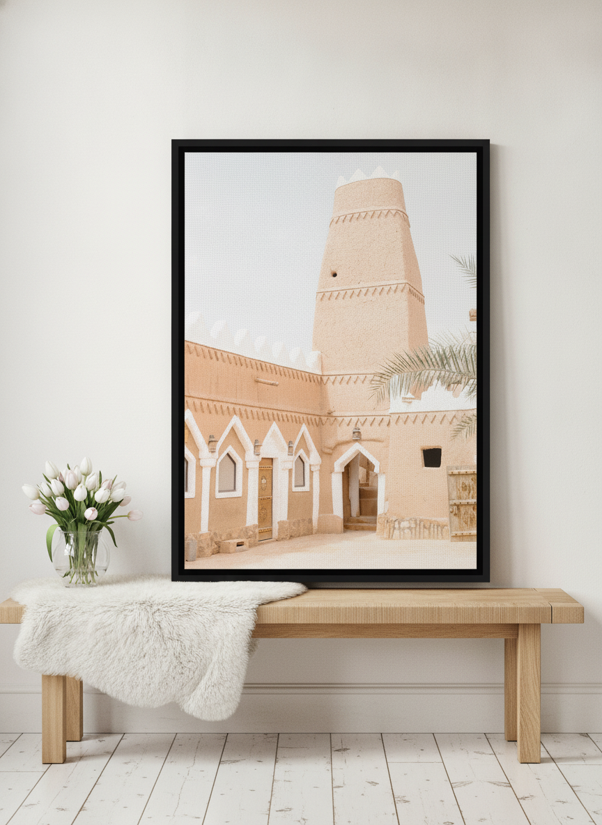 Canvas wall art with a black surround standing on a bench in a bright Scandinavian living room