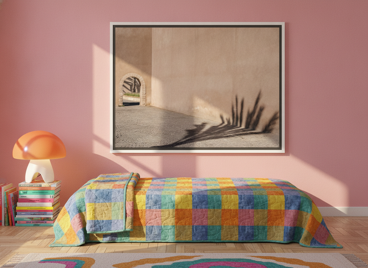 Canvas wall art with a white surround styled on the wall in a colourful eclectic bedroom